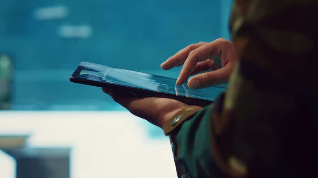 Army officer examines reconnaissance system on a world map