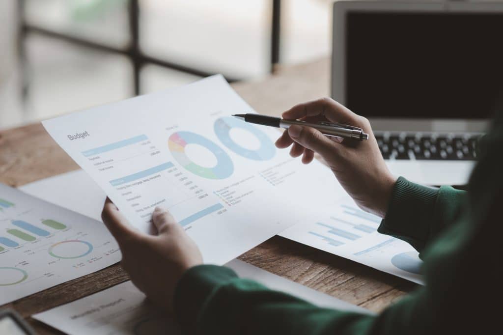 Business men are looking at the company's financial documents to analyze problems and find solutions